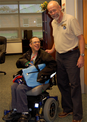 A student using a wheelchair and teacher at Edinboro College